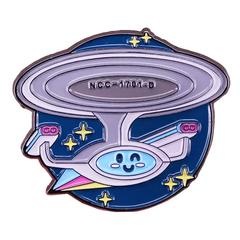 ST-Star X Trek enamel pin featuring a cartoon spaceship design with NCC-1701-D and starry background.