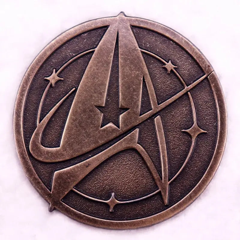 Vintage bronze enamel pin featuring a stylized letter 'A' with stars, ideal for accessory lovers.