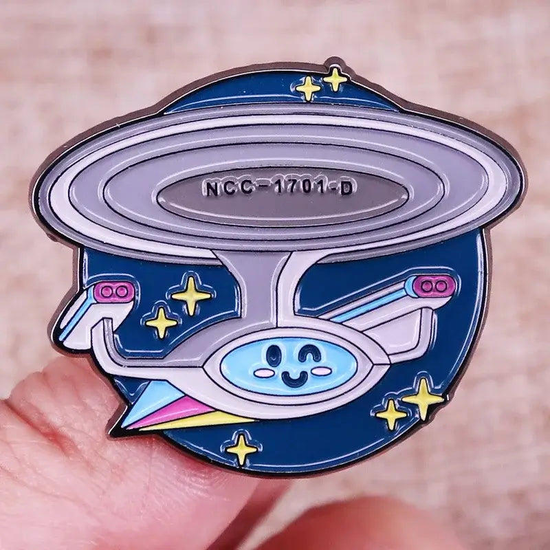Cute ST-Star X Trek enamel pin of the USS Enterprise NCC-1701-D with stars, perfect for backpacks and fashion accessories.