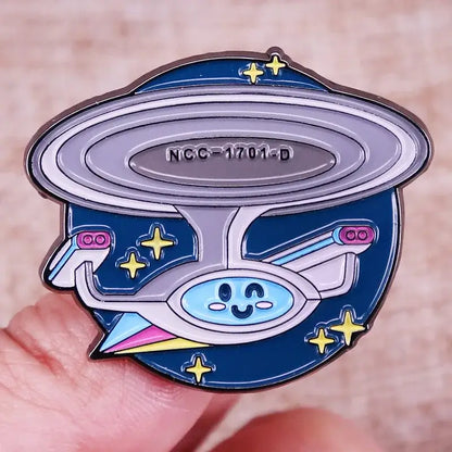Cute ST-Star X Trek enamel pin of the USS Enterprise NCC-1701-D with stars, perfect for backpacks and fashion accessories.
