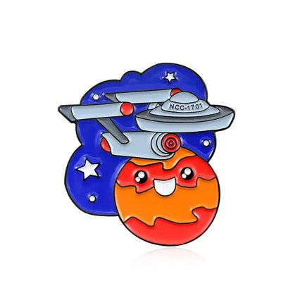 Colorful enamel pin featuring a smiling planet and a spaceship, ideal for backpacks and fashion accessories.